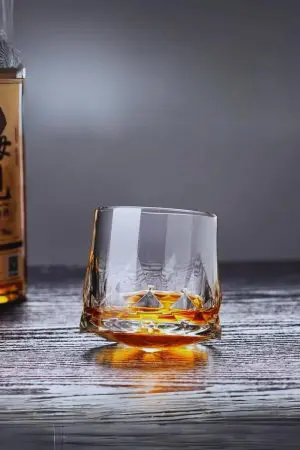 Verre à whisky en cristal rempli – Élégance et stabilité sur table.