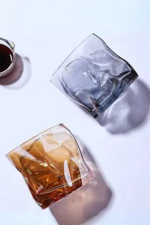 Verres à whisky en cristal teinté – Design ondulé avec reflets multicolores.
