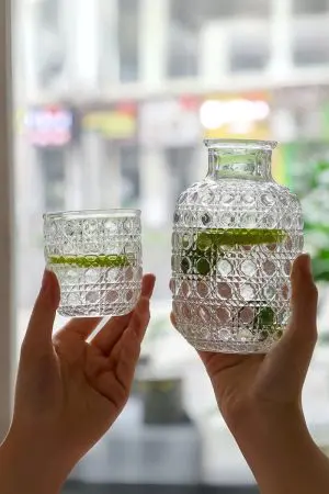 carafe à whisky vintage et verre assorti tenus en main, boisson citron vert